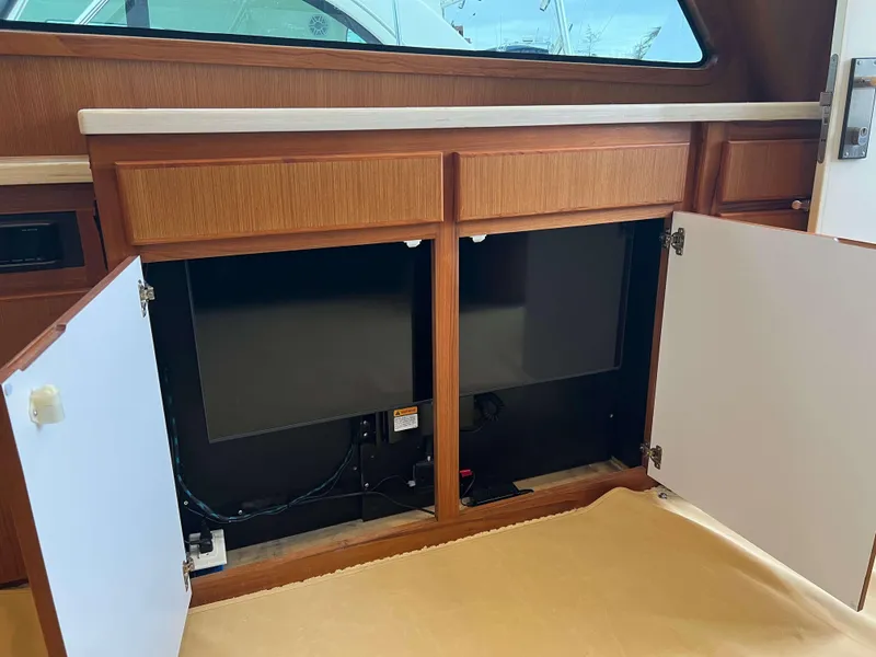 Slide: The Image of Open cabinet doors on a 2021 Henriques 50 Sportfisherman boat. - 47
