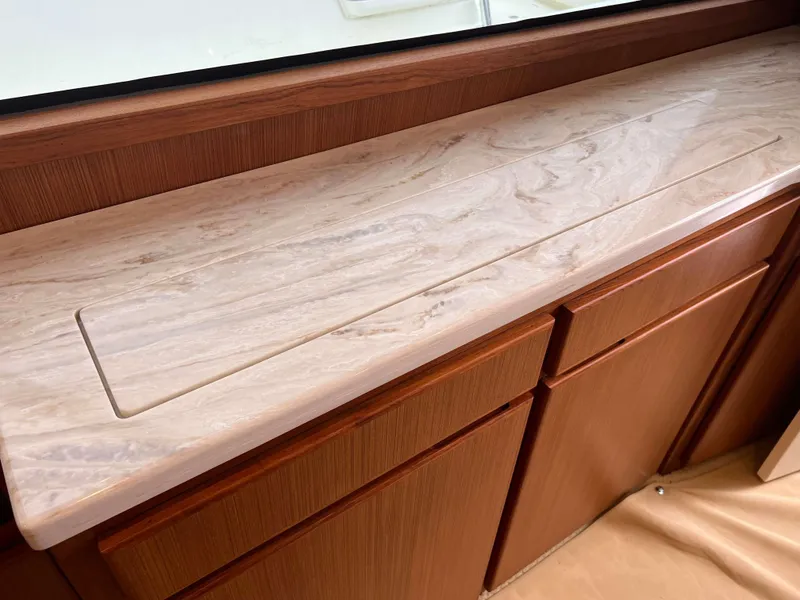 Slide: The Image of Henriques 50 Sportfisherman 2021 interior, marble countertop with wooden cabinets. - 48