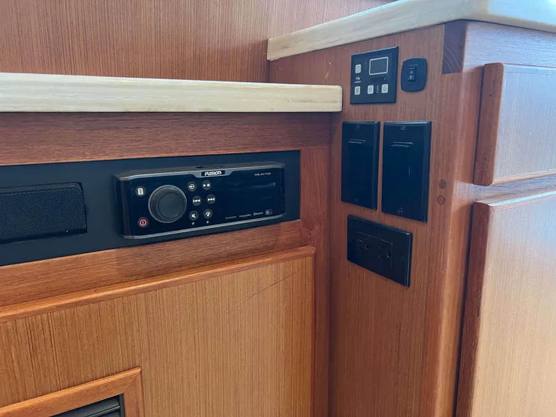 Slide: The Image of Henriques 50 Sportfisherman 2021 interior control panel and audio system. - 49