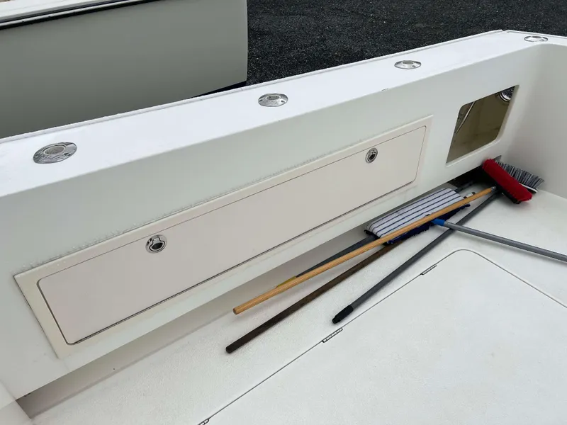 Slide: The Image of Henriques 50 Sportfisherman 2021 deck with storage compartments and cleaning tools. - 7
