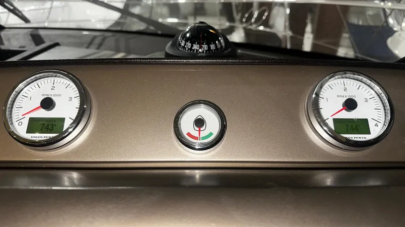 Slide: The Image of Dashboard of a 2013 Prestige 500 yacht with gauges and compass. - 12