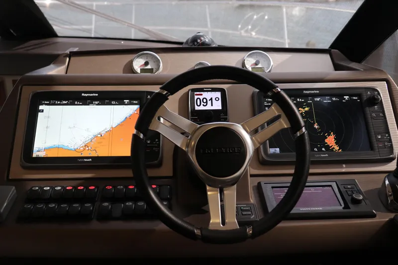 Slide: The Image of Prestige 500 yacht helm with navigation screens and controls, 2013 model. - 14