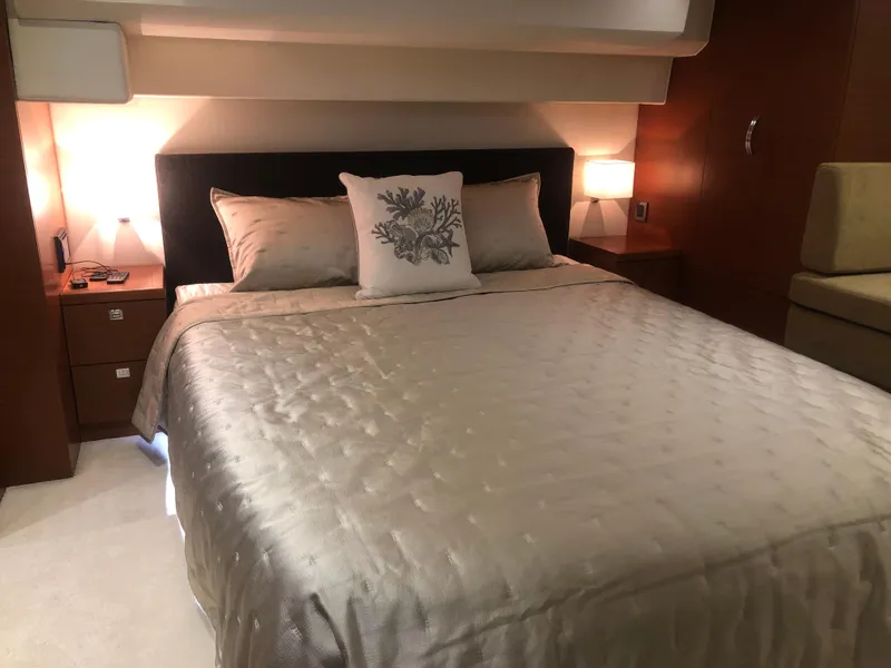 Slide: The Image of Luxurious bedroom in a 2013 Prestige 500 yacht with elegant bedding and ambient lighting. - 16