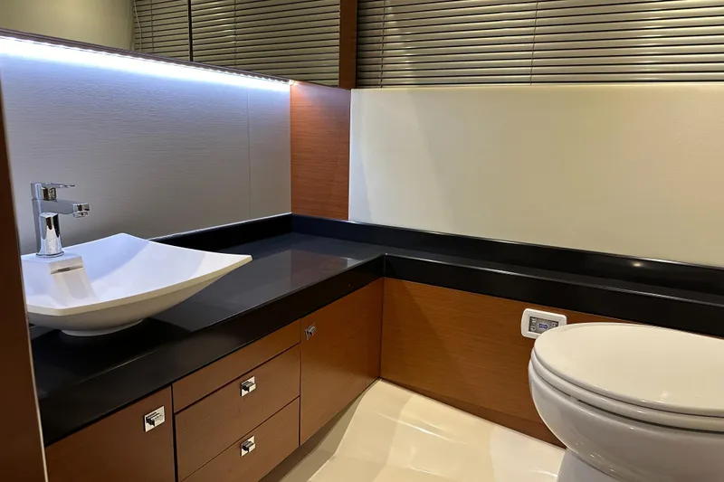 Slide: The Image of Modern bathroom in a 2013 Prestige 500 yacht with sleek fixtures and wooden cabinetry. - 21