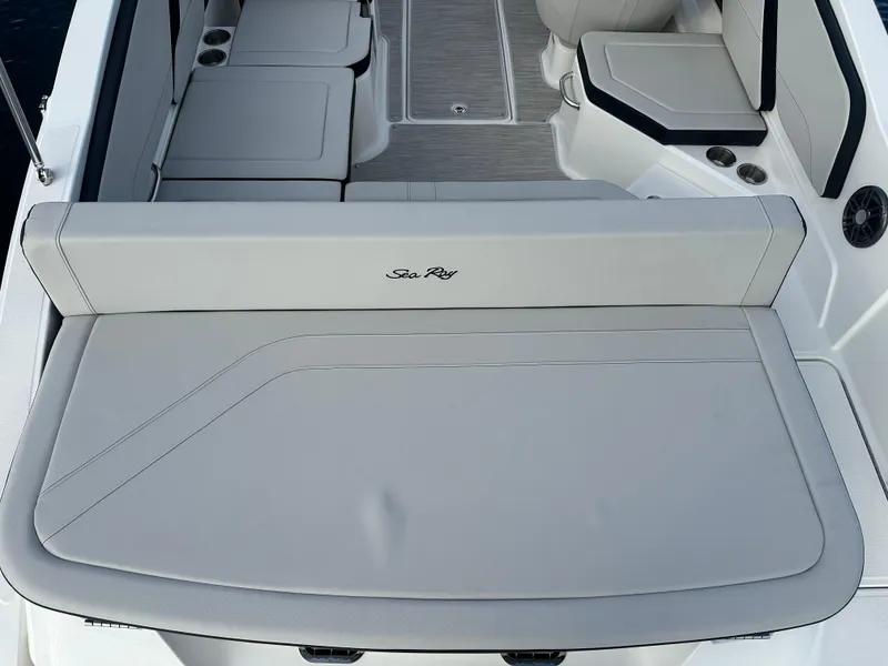 Slide: The Image of 2024 Sea Ray SPX 210 boat interior with cushioned seating and storage compartments. - 10