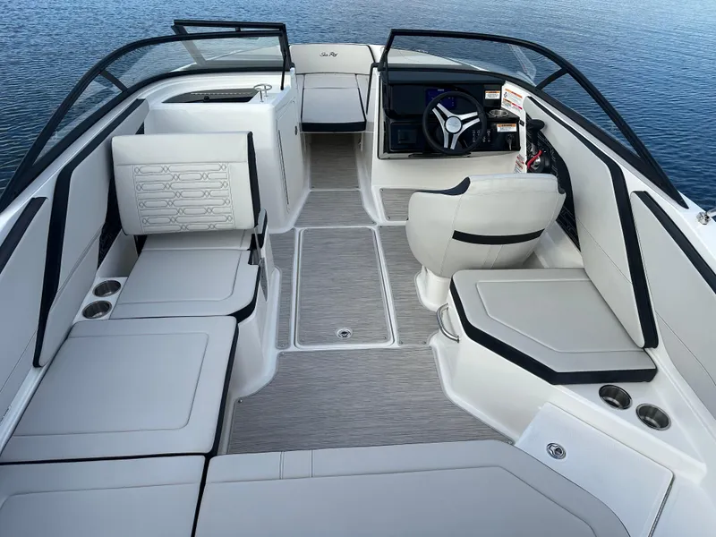 Slide: The Image of 2024 Sea Ray SPX 210 boat interior with white seating and steering console. - 11