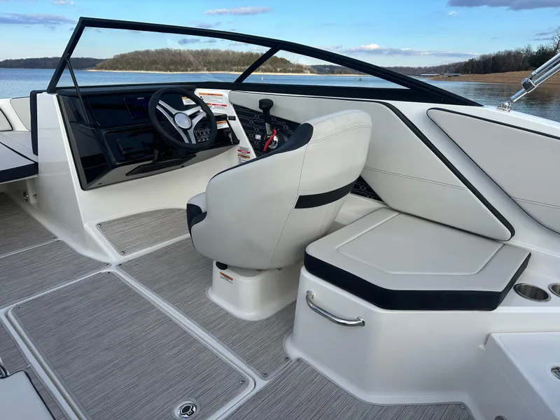 Slide: The Image of 2024 Sea Ray SPX 210 boat interior with steering wheel and seating. - 12
