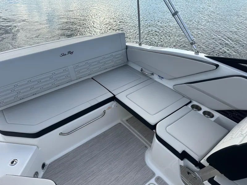 Slide: The Image of 2024 Sea Ray SPX 210 boat interior with white cushioned seating. - 13