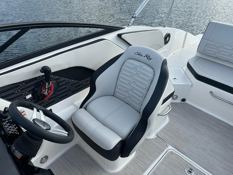 Slide: The Image of 2024 Sea Ray SPX 210 boat interior with captain's chair and steering wheel. - 14