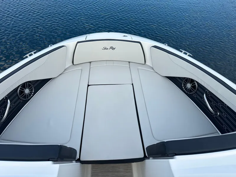 Slide: The Image of 2024 Sea Ray SPX 210 boat bow seating area on water. - 16