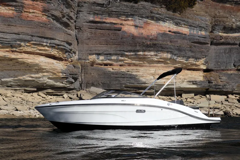 Slide: The Image of 2024 Sea Ray SPX 210 boat cruising near rocky cliffs. - 6