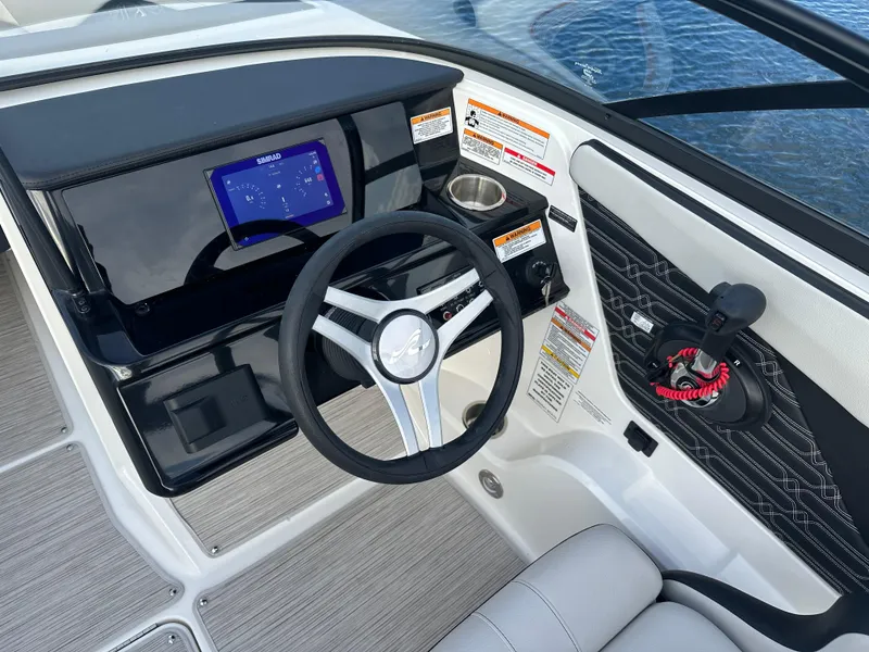 Slide: The Image of 2024 Sea Ray SPX 210 boat cockpit with steering wheel and control panel. - 8