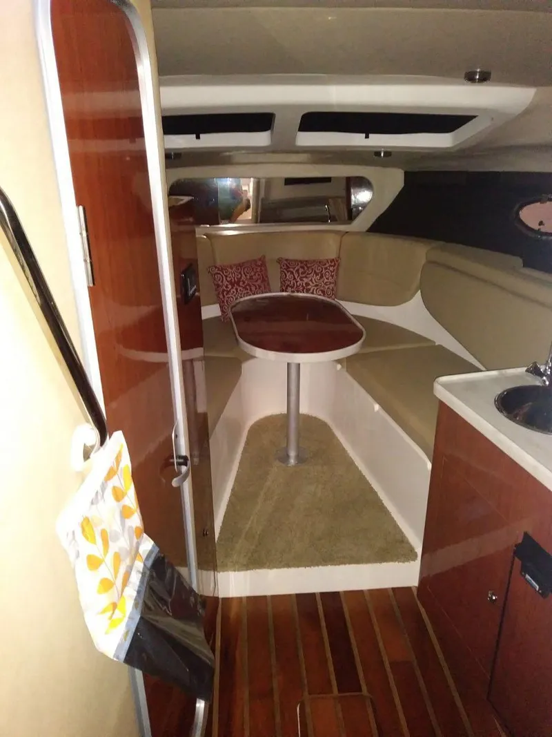 Slide: The Image of 2012 Regal 3060 Express Cruiser interior with seating and table. - 12