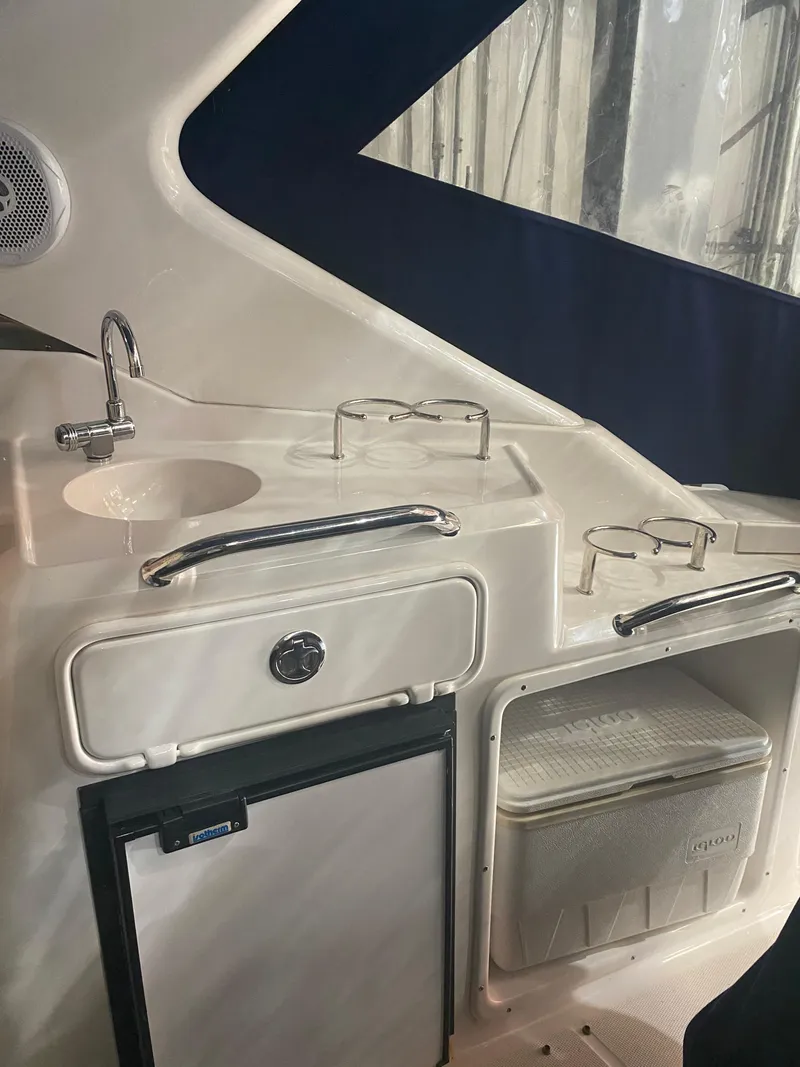 Slide: The Image of Interior of 2012 Regal 3060 Express Cruiser with sink and fridge. - 14