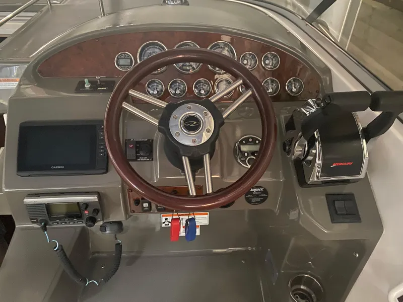 Slide: The Image of 2012 Regal 3060 Express Cruiser helm with wood steering wheel. - 16