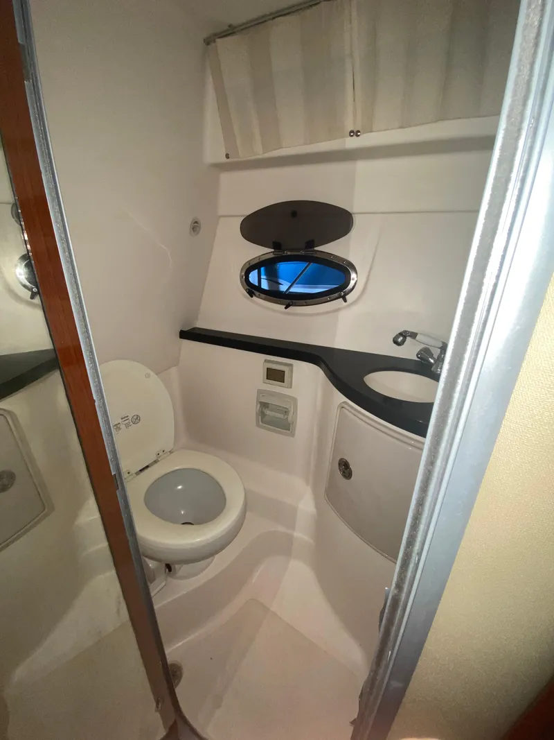 Slide: The Image of Bathroom of 2012 Regal 3060 Express Cruiser with toilet and sink. - 18