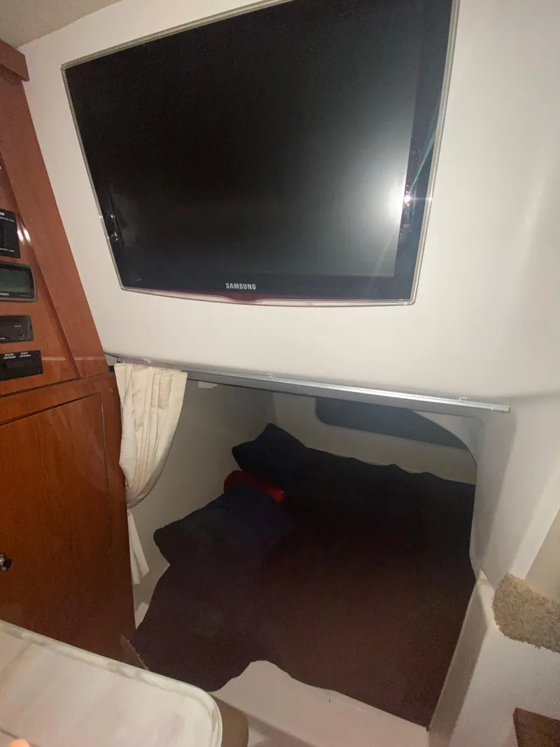 Slide: The Image of Interior of 2012 Regal 3060 Express Cruiser with TV and sleeping area. - 19