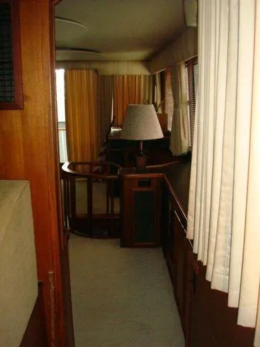 Slide: The Image of Interior of 1988 Chris-Craft Constellation yacht with wood paneling and curtains. - 16