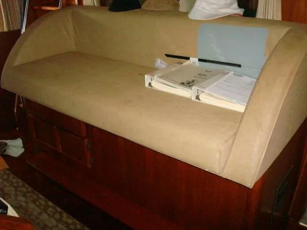 Slide: The Image of 1988 Chris-Craft Constellation interior with beige sofa and wooden cabinetry. - 17
