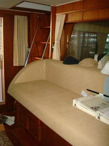 Slide: The Image of 1988 Chris-Craft Constellation interior with beige seating and wooden accents. - 18