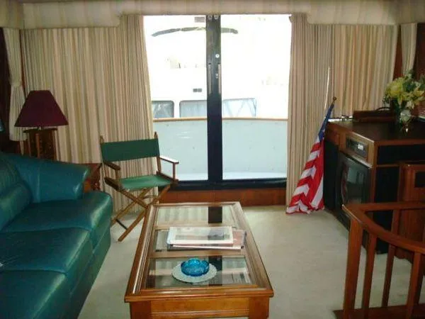 Slide: The Image of Interior of 1988 Chris-Craft Constellation yacht with seating, table, and American flag. - 24