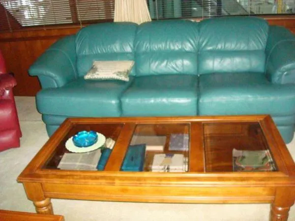 Slide: The Image of Teal leather sofa and wooden coffee table inside 1988 Chris-Craft Constellation yacht. - 25