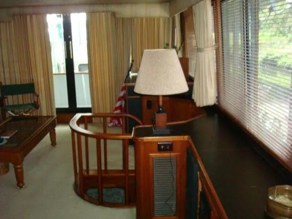Slide: The Image of Interior of 1988 Chris-Craft Constellation yacht with wooden furnishings and large windows. - 27