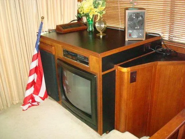 Slide: The Image of 1988 Chris-Craft Constellation interior with vintage TV, American flag, and decor elements. - 29