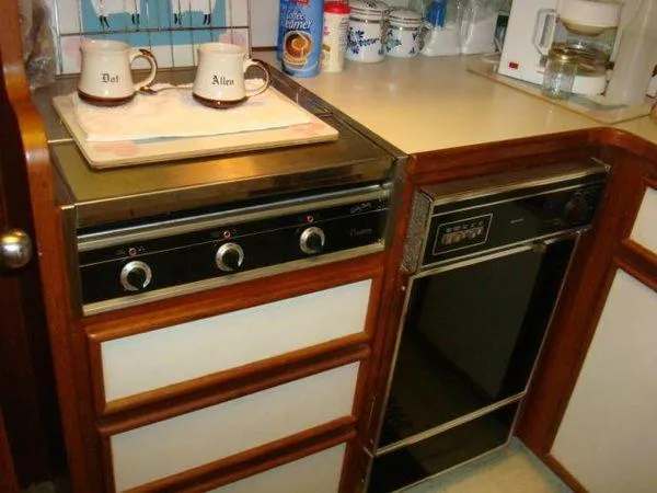 Slide: The Image of 1988 Chris-Craft Constellation kitchen with stove, dishwasher, and coffee maker. - 32