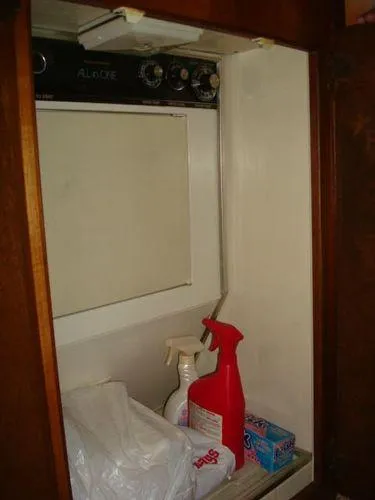 Slide: The Image of Laundry area inside 1988 Chris-Craft Constellation boat with cleaning supplies. - 35