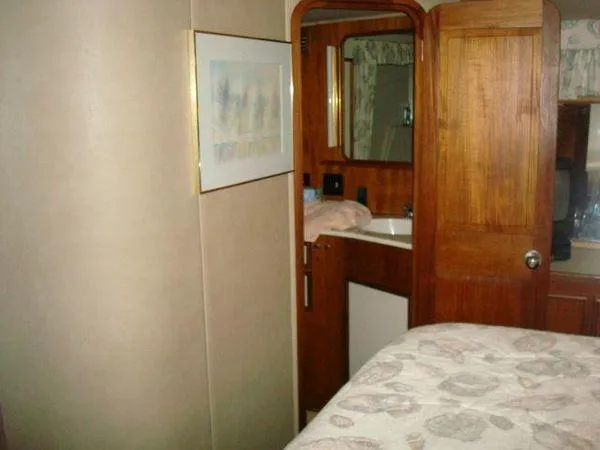Slide: The Image of Interior of 1988 Chris-Craft Constellation yacht with wood paneling and cozy decor. - 44