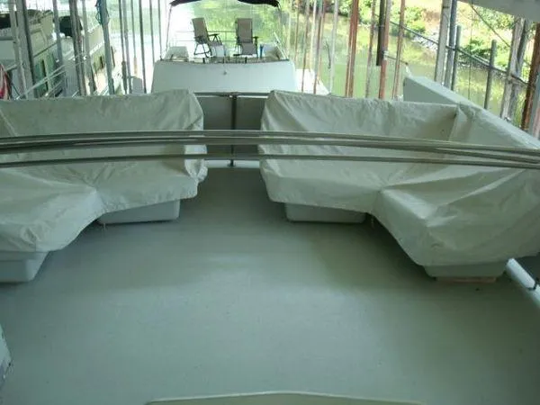 Slide: The Image of 1988 Chris-Craft Constellation boat deck with covered seating and scenic water view. - 8