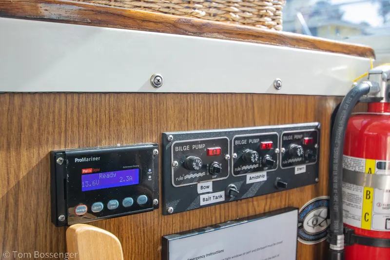 Slide: The Image of Control panel of a 1976 Bertram 35 Convertible boat with bilge pump switches and fire extinguisher. - 17