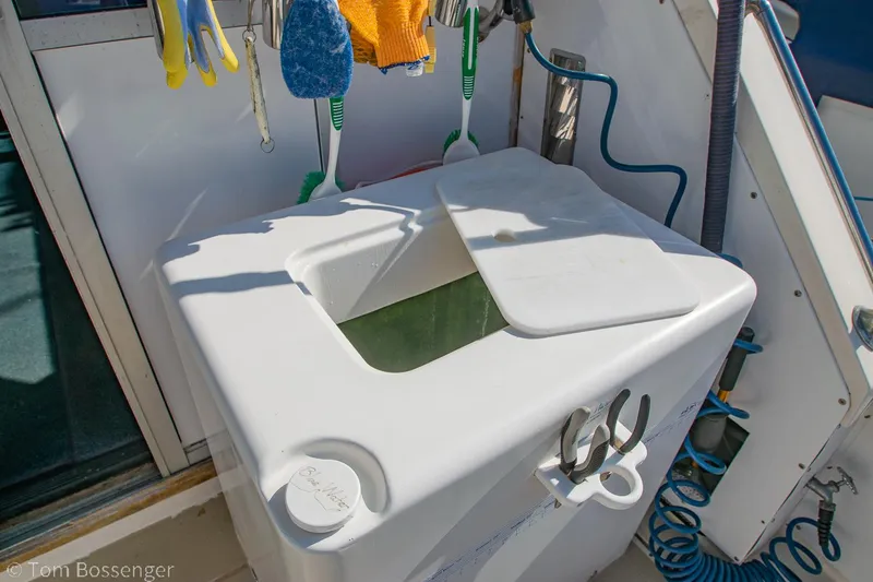 Slide: The Image of Fishing equipment and storage on a 1976 Bertram 35 Convertible boat deck. - 27