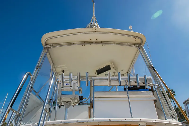 Slide: The Image of 1976 Bertram 35 Convertible boat, viewed from below, against a clear blue sky. - 29