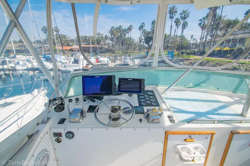 Slide: The Image of Helm of 1976 Bertram 35 Convertible with marina view and navigation equipment. - 30