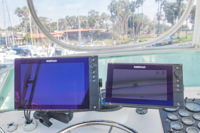 Slide: The Image of Simrad navigation screens on a 1976 Bertram 35 Convertible boat dashboard. - 33