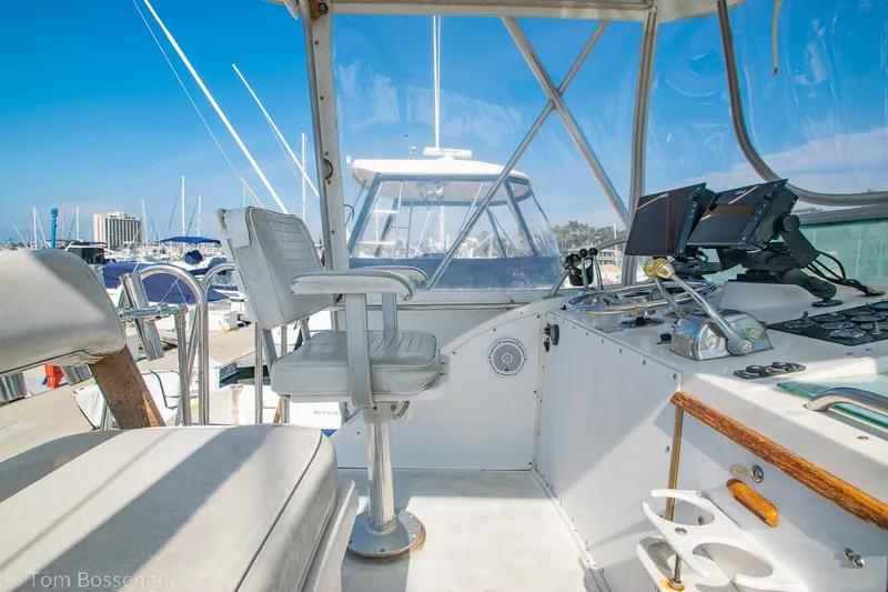 Slide: The Image of 1976 Bertram 35 Convertible boat cockpit with helm, seating, and navigation equipment. - 34