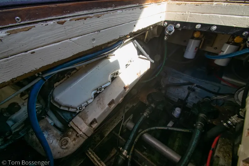 Slide: The Image of Engine compartment of a 1976 Bertram 35 Convertible boat, showing mechanical components and hoses. - 40