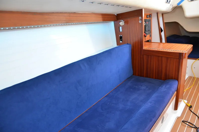 Slide: The Image of Interior of 2011 J Boats J/111 with blue seating and wooden accents. - 17