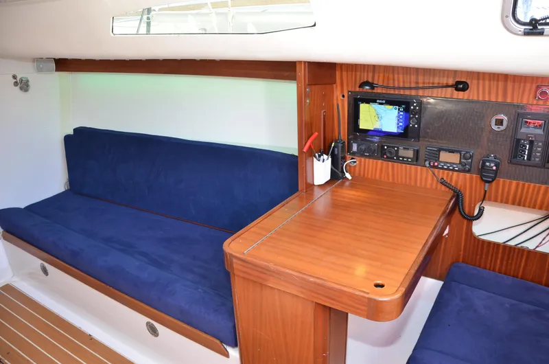 Slide: The Image of Interior of 2011 J Boats J/111 sailboat with blue seating and navigation equipment. - 18