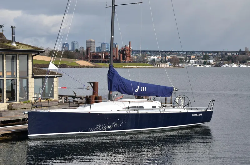Slide: The Image of 2011 J Boats J/111 sailboat docked by a waterfront house. - 2