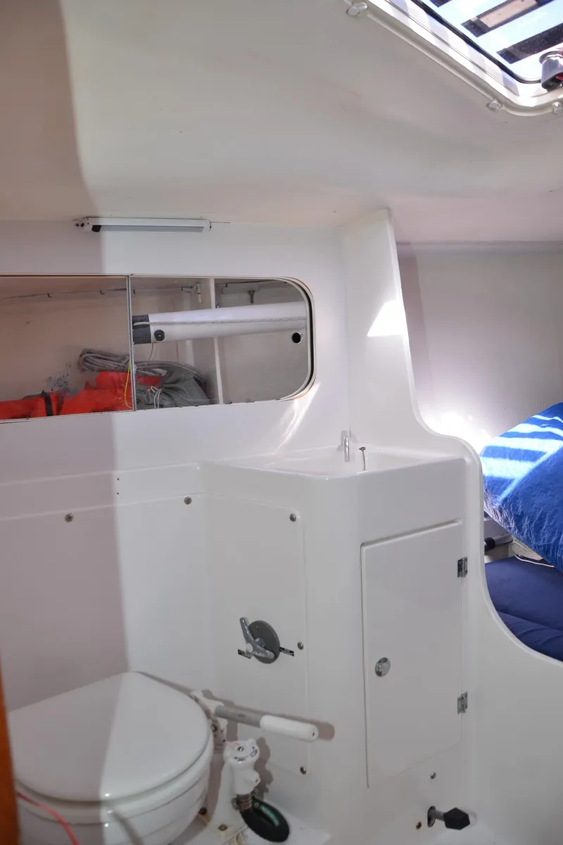 Slide: The Image of Interior of 2011 J Boats J/111 sailboat, featuring compact bathroom and storage area. - 24