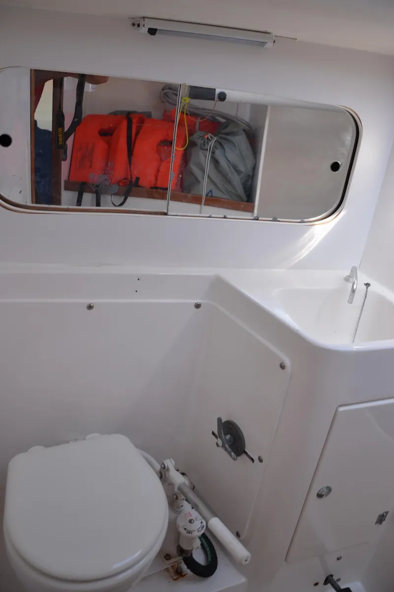 Slide: The Image of 2011 J Boats J/111 yacht bathroom with storage and life jackets. - 25