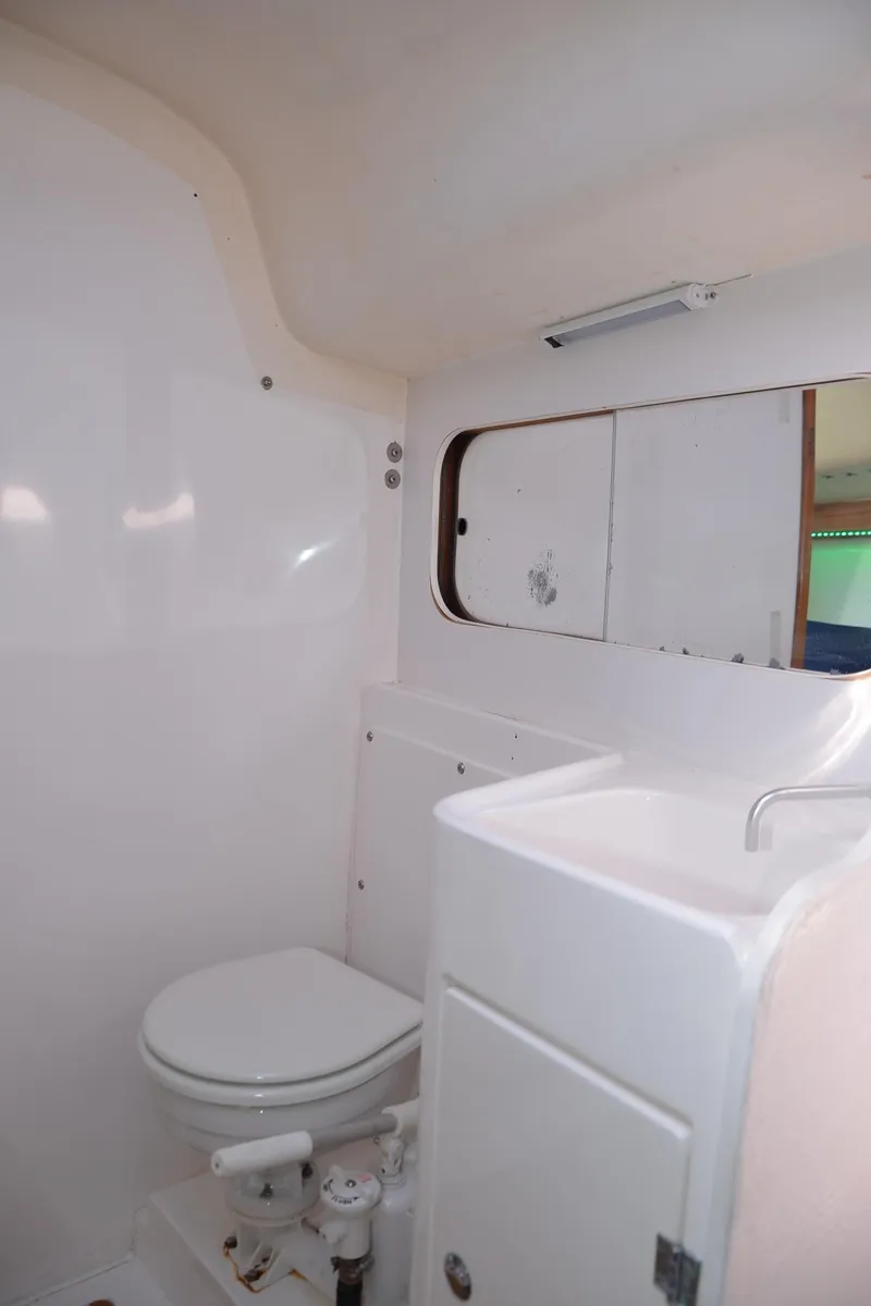 Slide: The Image of 2011 J Boats J/111 yacht bathroom with white fixtures and mirror. - 26