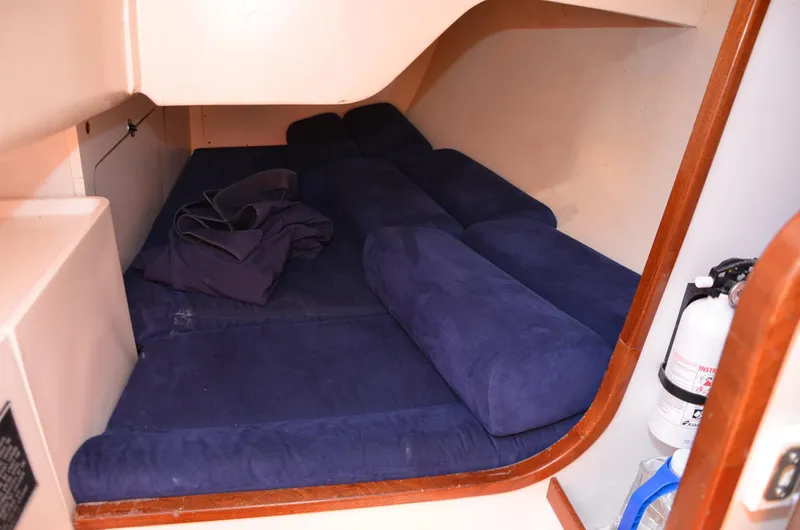 Slide: The Image of 2011 J Boats J/111 cabin with blue cushions and fire extinguisher. - 28