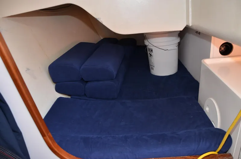 Slide: The Image of Interior cabin of 2011 J Boats J/111 with blue cushions and storage bucket. - 29