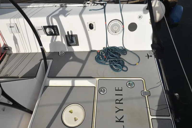 Slide: The Image of Cockpit of 2011 J Boats J/111 sailboat with coiled blue rope and Kyrie nameplate. - 33
