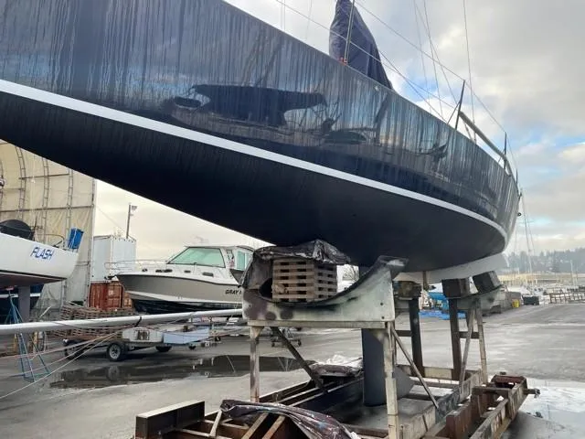 Slide: The Image of 2011 J Boats J/111 sailboat on dry dock, showcasing sleek hull design. - 40