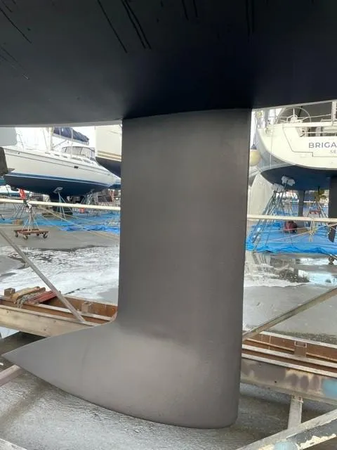 Slide: The Image of 2011 J Boats J/111 keel in dry dock, surrounded by other boats. - 44